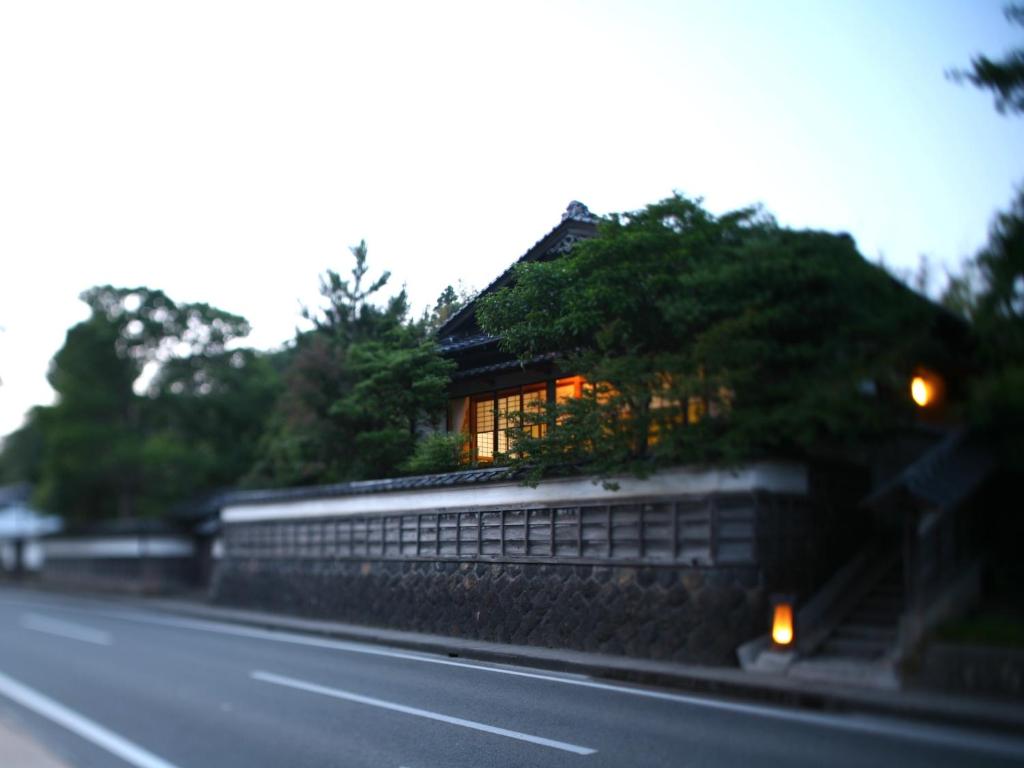 a house sitting on the side of a road at 縁の宿 北堀 in Matsue