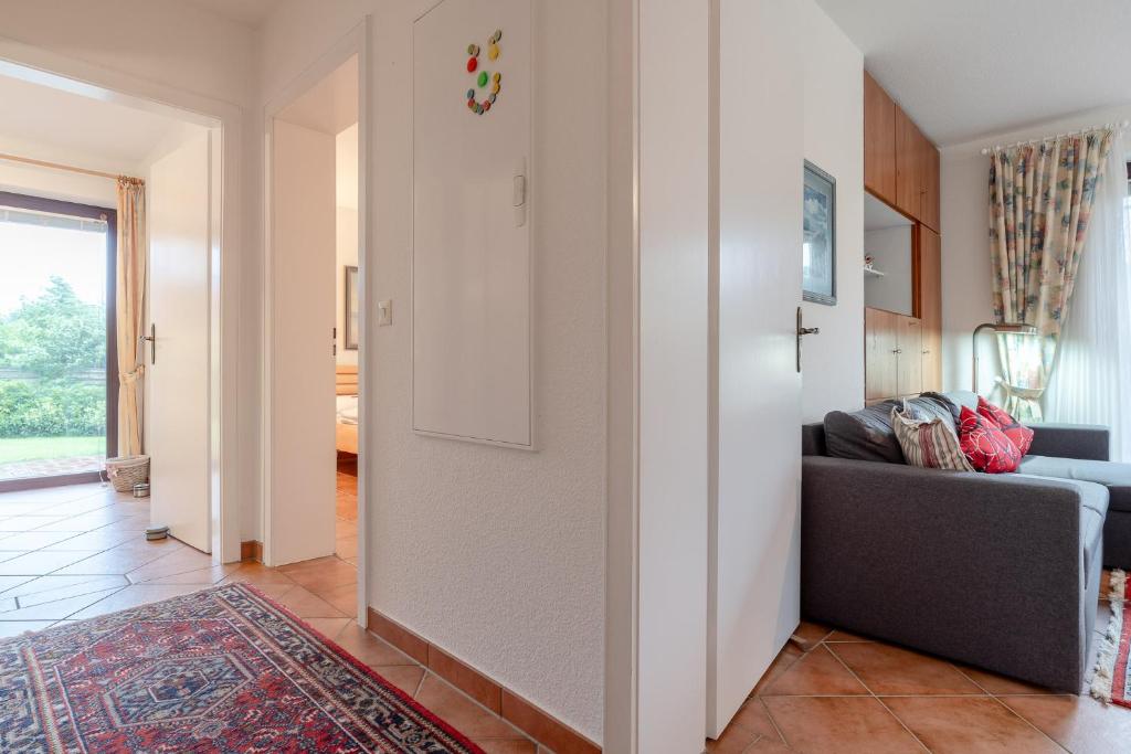 a living room with a couch and a window at Romantica EG in Sankt Peter-Ording
