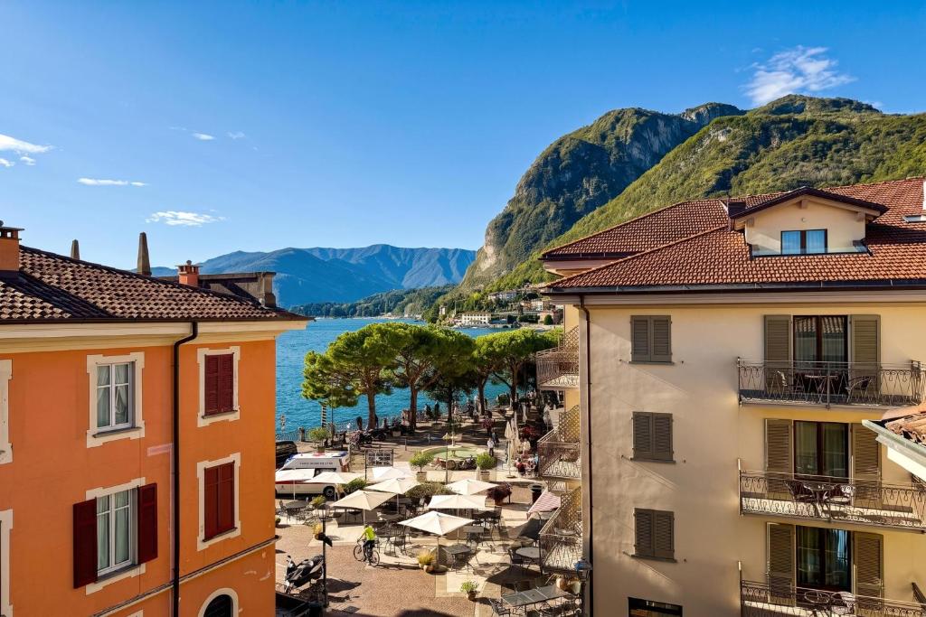 a view of a town with a beach and mountains at La Piazza Menaggio in Menaggio