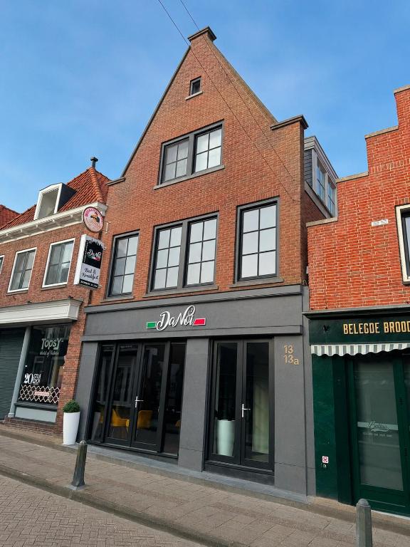 a brick building on the side of a street at Harbour Stay Volendam in Volendam
