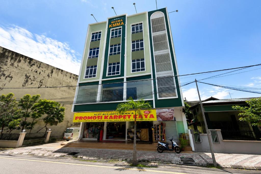 a building with a motorcycle parked in front of it at KM Barakah Suite Kuala Terengganu in Kuala Terengganu