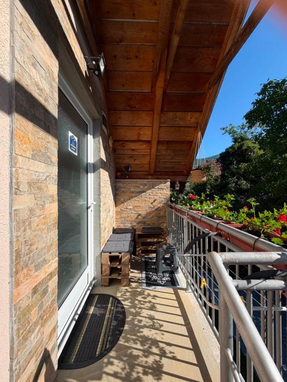 a balcony of a house with a wooden ceiling at Jasmin in Jošanička Banja