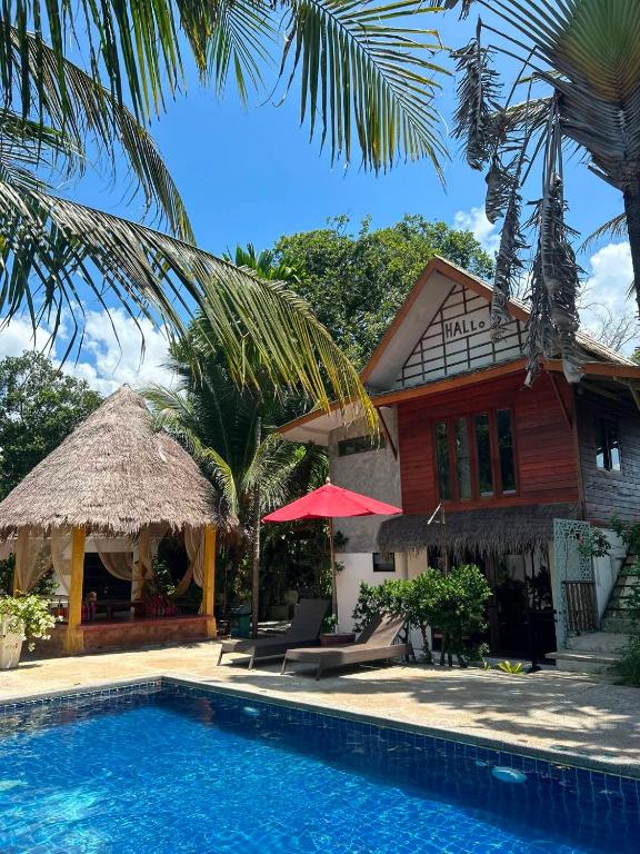 a house with a swimming pool in front of a house at Hallo Villa Khanom in Khanom