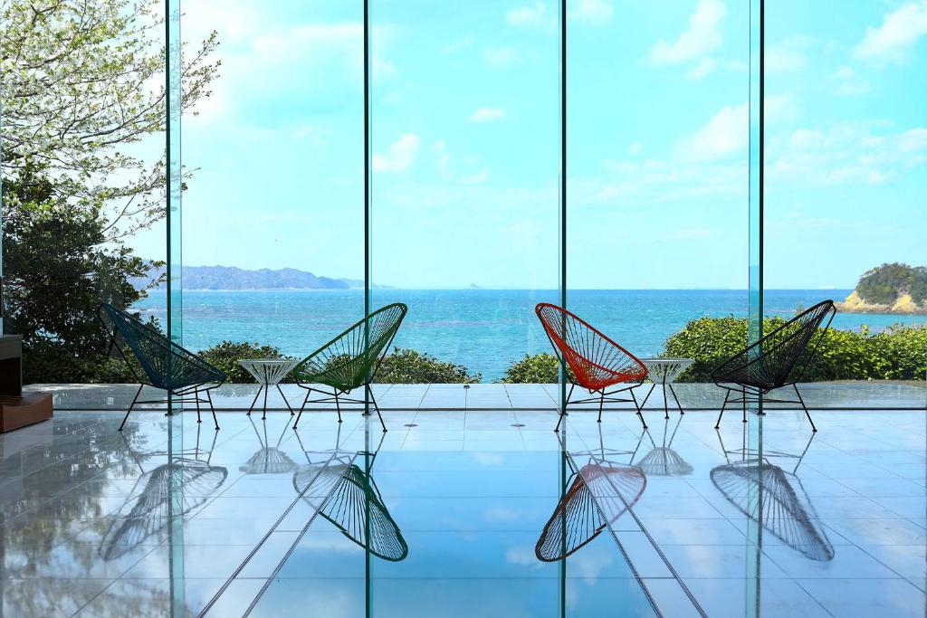 a group of chairs sitting in front of a window at TAOYA Shima in Toba
