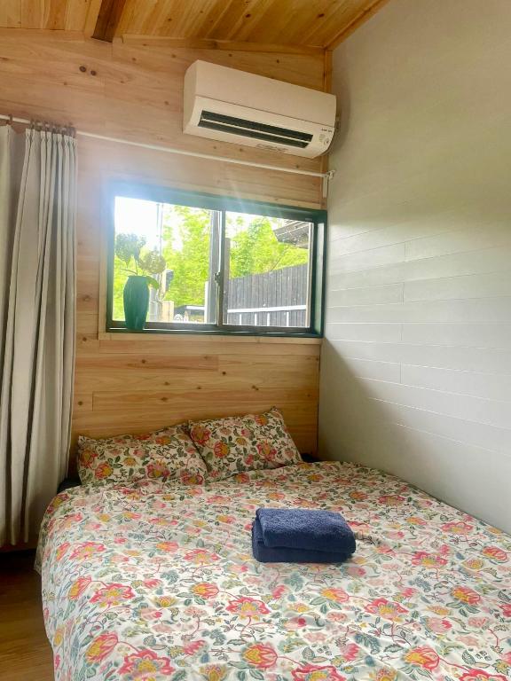 a bed in a small room with a window at Foresta Karuizawa 7 Glamping & camping for 8 people in Naganohara