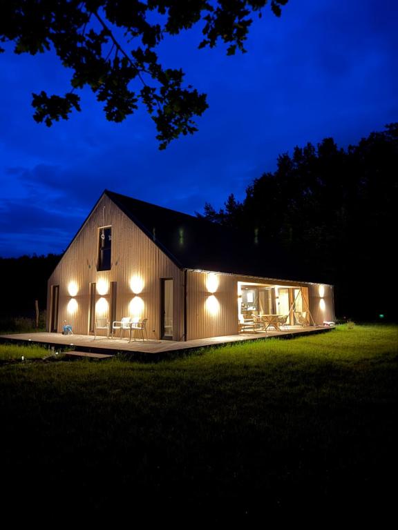 a barn with lights on it at night at Radawa LOVE in Radawa
