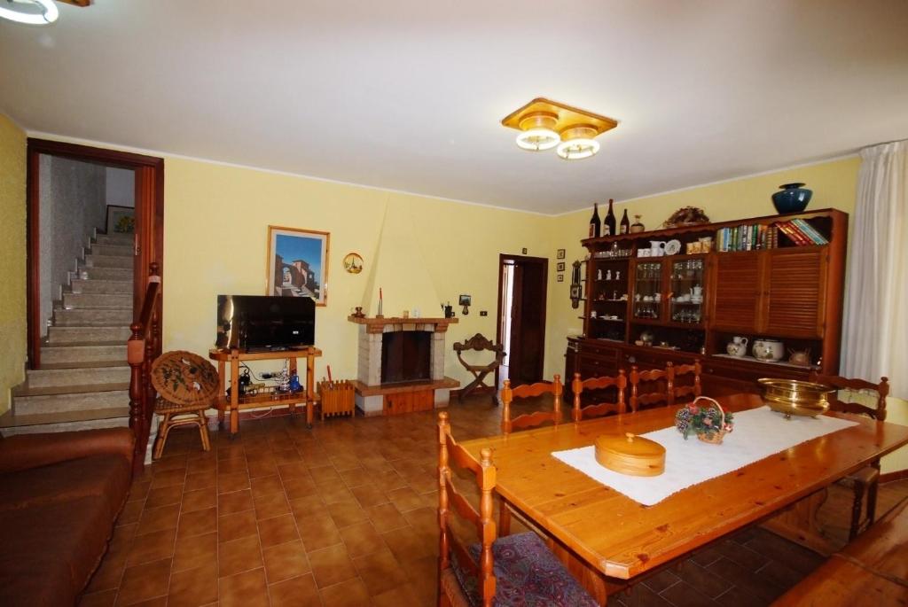 a living room with a table and a fireplace at I due cipressi in Cagli