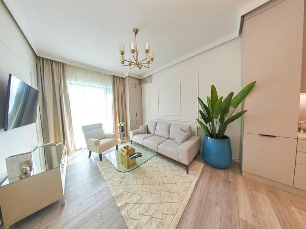 a living room with a couch and a table at Apartament Marreo Casa del Mar in Mamaia