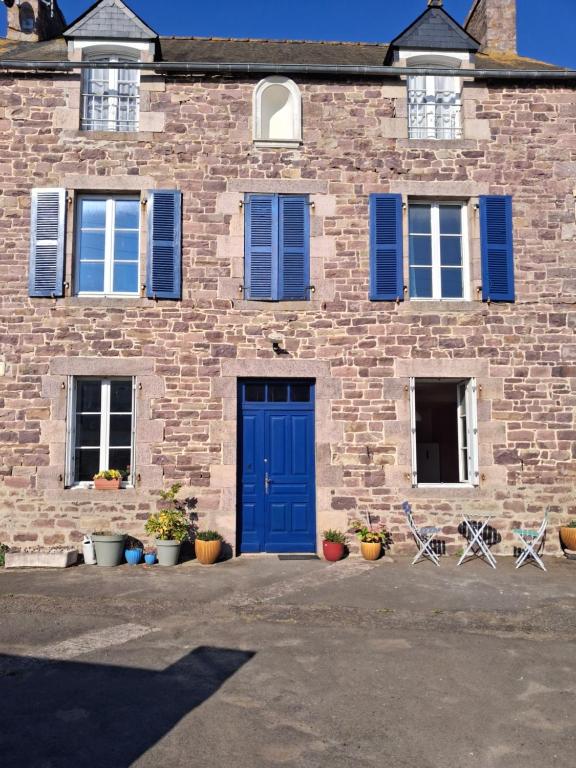 a brick building with blue doors and windows at Chambres d'hôtes Frehel in Fréhel