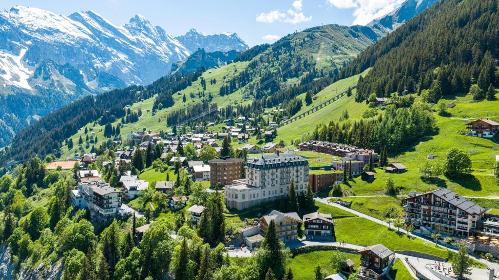 an aerial view of a resort in the mountains at Hotel Mürren Palace in Mürren