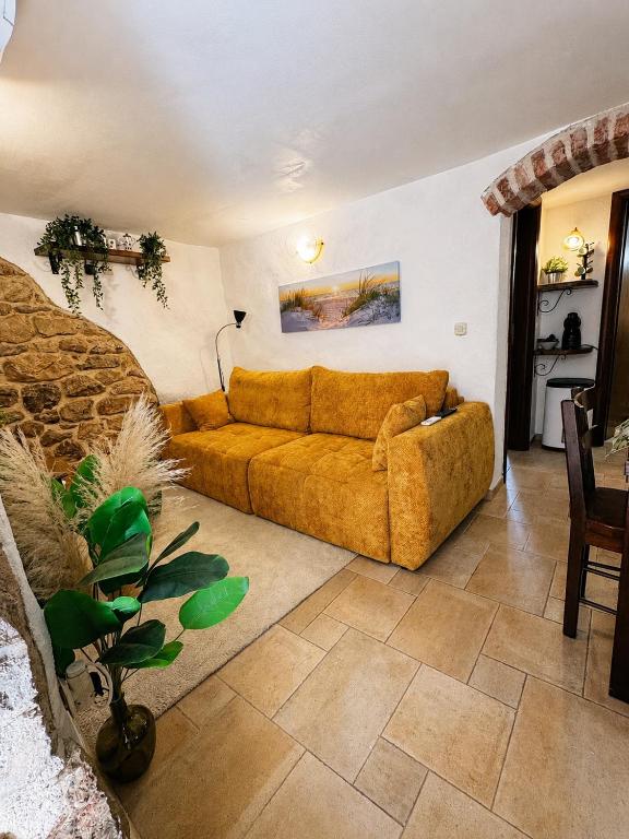 a living room with a couch and a table at Biba Holiday in Omišalj