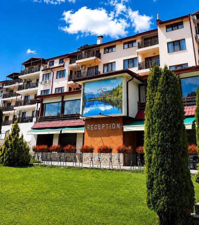 a building with a large mural on the side of it at Tryavna Lake Hotel & SPA in Tryavna