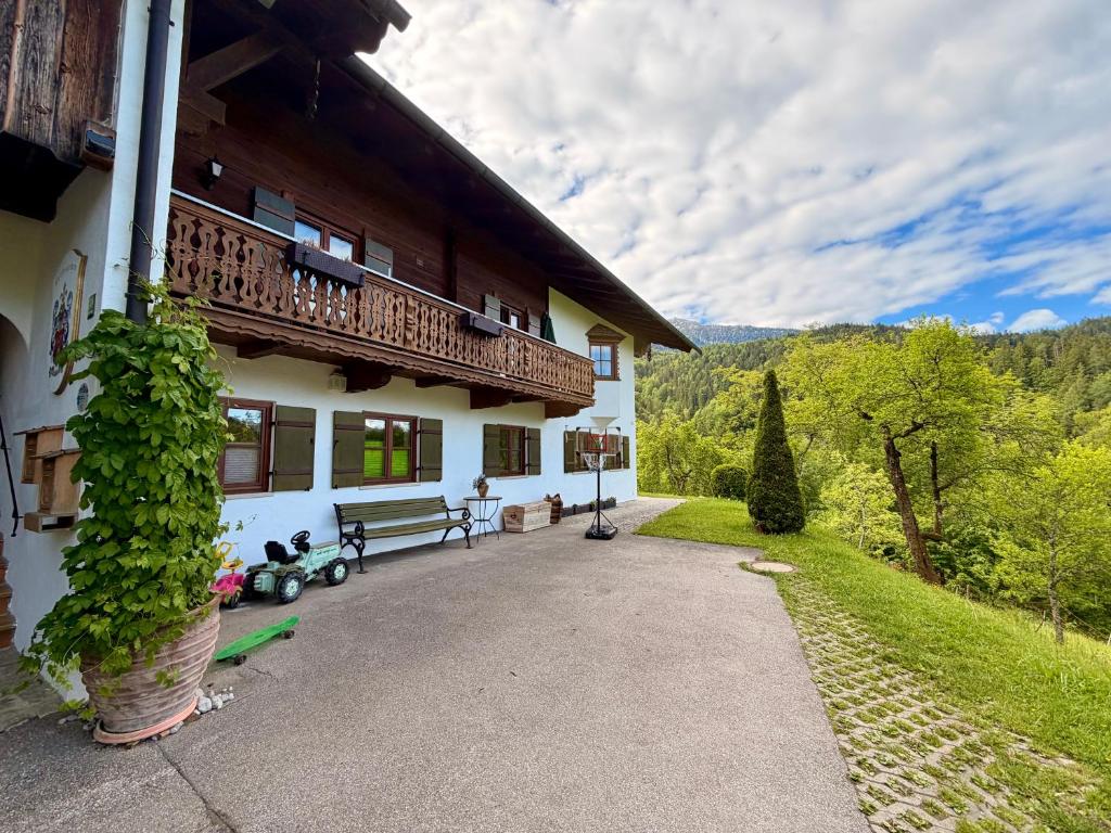a house with a balcony on the side of it at Bergbauernhof Leitenlehen in Berchtesgaden