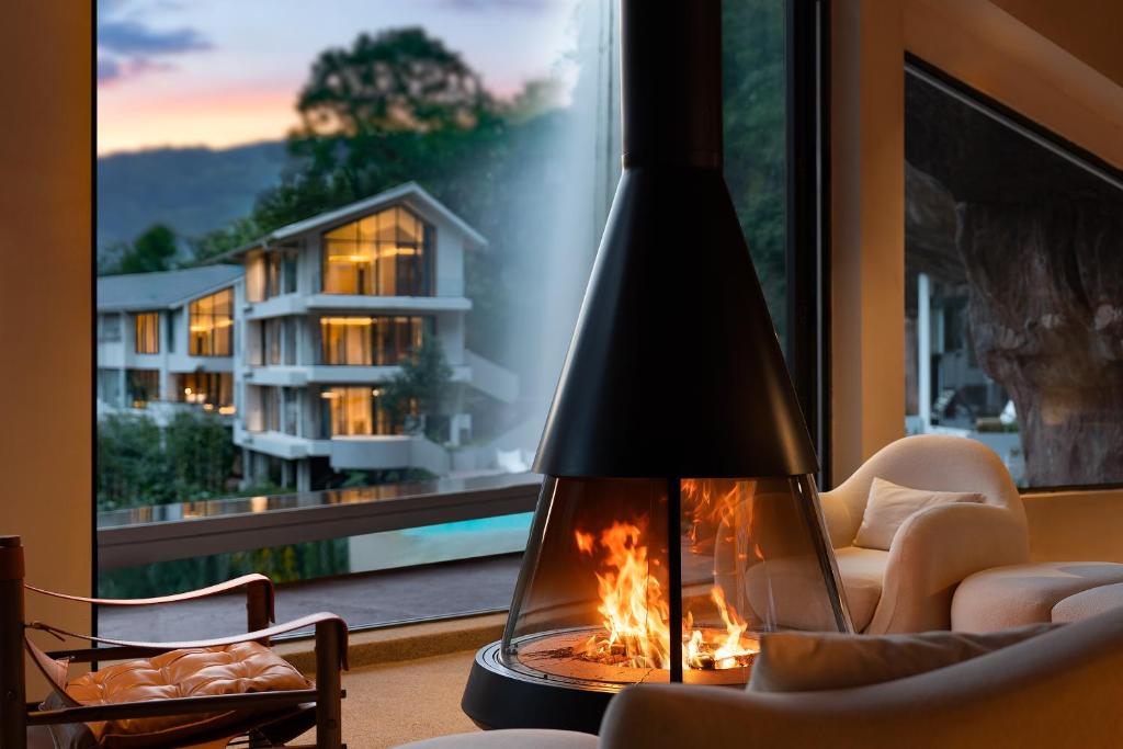 a fireplace in a living room with a view of a building at Enjoy nature Be energetic in Yunji