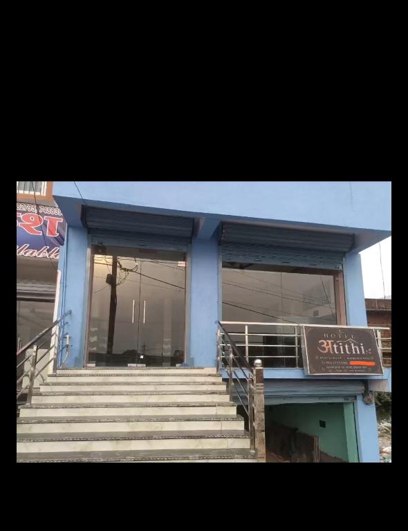a blue building with stairs and a sign on it at HOTEL अtithi in Rājgīr