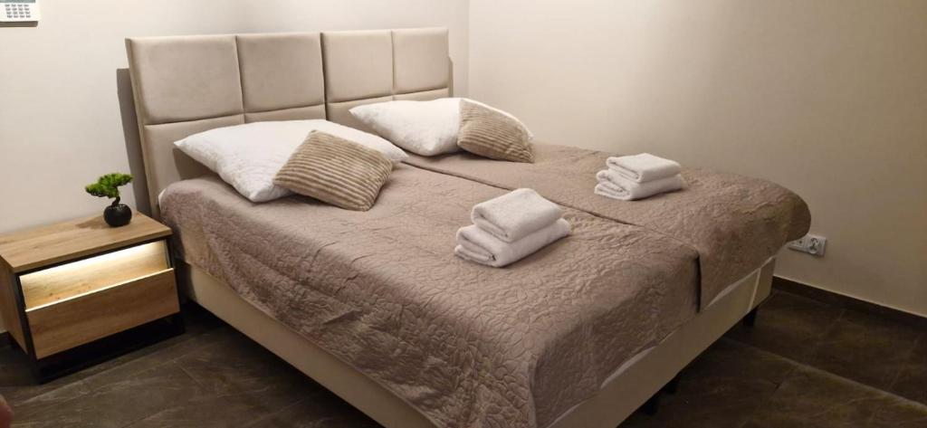 a bedroom with a bed with towels on it at Breakpoint Loft - City Center in Łobez