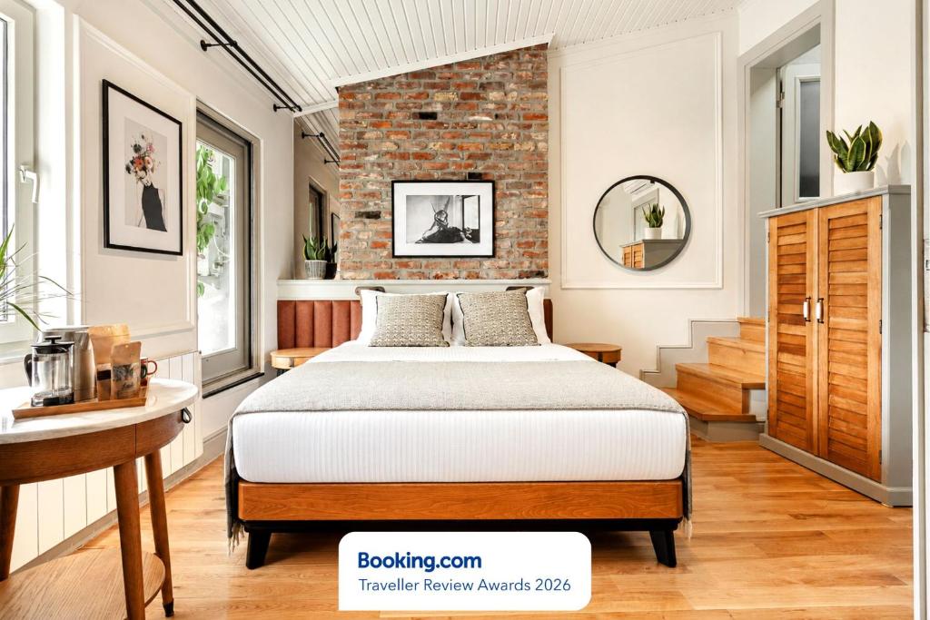 a bedroom with a bed and a brick wall at World House Boutique Hotel Galata in Istanbul
