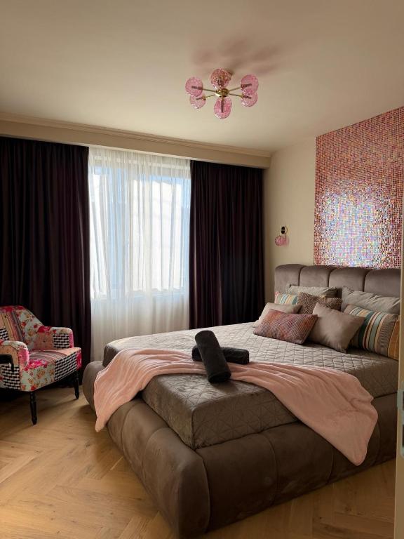 a bedroom with a large bed and a ceiling fan at GZP Residence Lugoj 5 in Lugoj