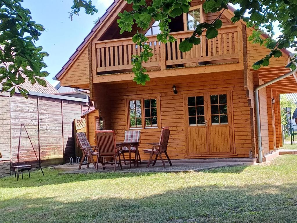 a house with a table and chairs in front of it at Holiday Home Fleesensee in Göhren-Lebbin