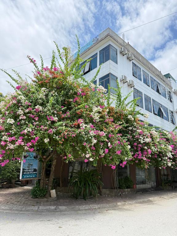 a building with pink flowers in front of it at LD Housing 9 in Ðống Thôn