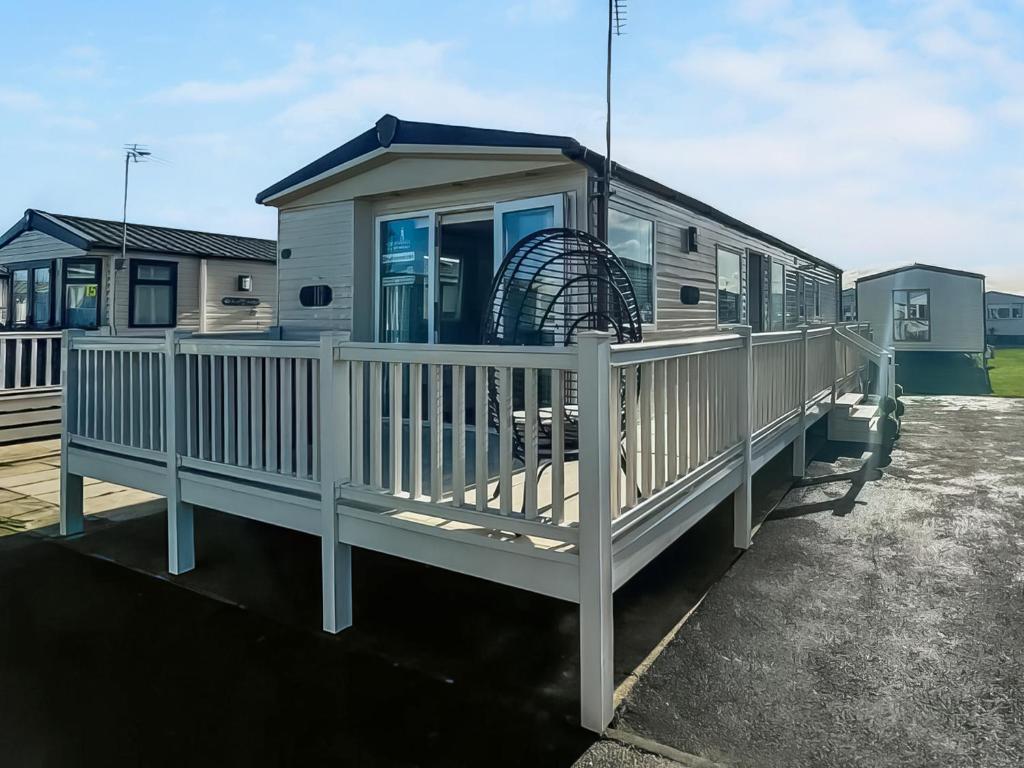 a mobile home with a deck and a ferris wheel at Abi St David - Ukc9615 in Rowen