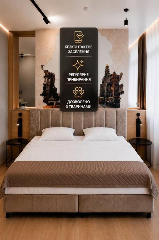 a bedroom with a bed with a sign above it at Manhattan High Line Apart in Kyiv