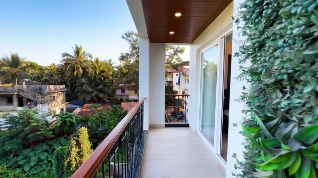 a balcony of a house with plants on it at Calangute Heights in Calangute