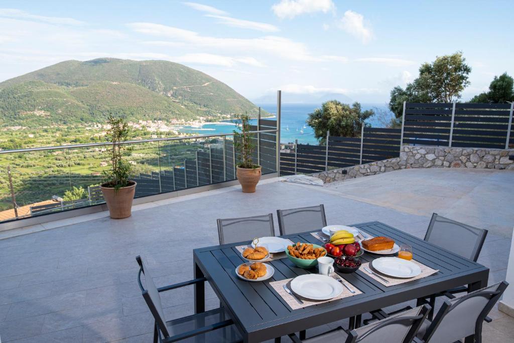 a table with food on top of a balcony at Aifantis Villa 2 in Póndi