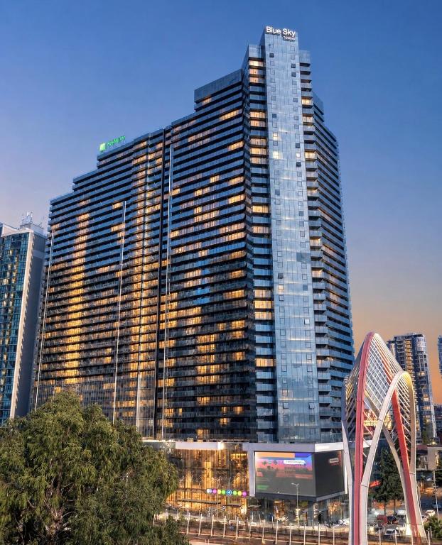 a large building with a sign in front of it at Blue Sky Apart-Hotel Batumi in Batumi