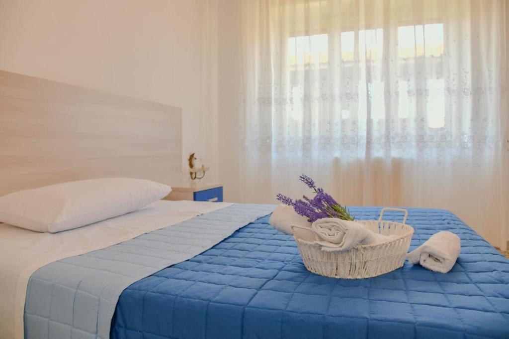 ein Schlafzimmer mit einem Bett und einem Korb mit Handtüchern in der Unterkunft Le Sciosce in San Giorgio Lucano