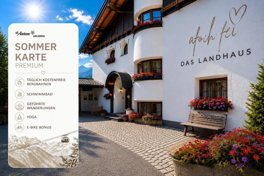 a building with a sign in front of it at Quality Hosts Arlberg - AFOCH FEI - das Landhaus I SOMMERKARTE PREMIUM in Sankt Anton am Arlberg