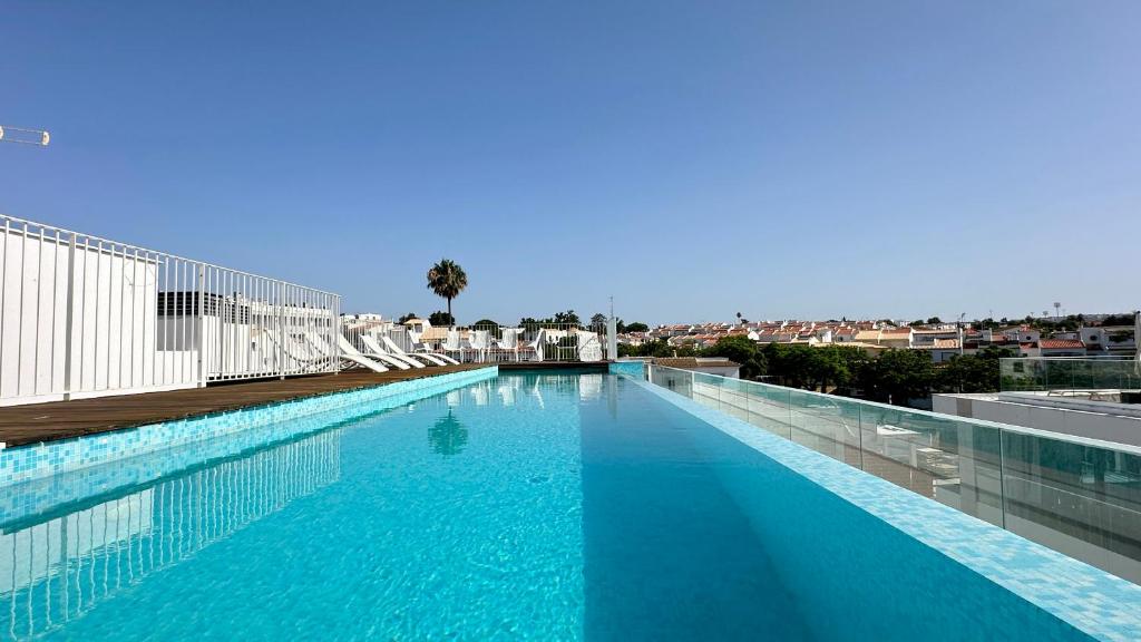 a large swimming pool on the roof of a building at Prime - Shared Pool - 6 Guests - Albufeira in Albufeira