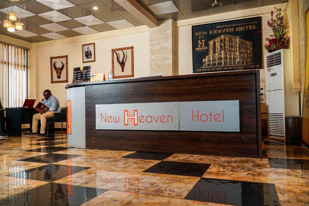 a lobby with a newhaven hotel sign on the wall at New Heaven Hôtel in Yaoundé