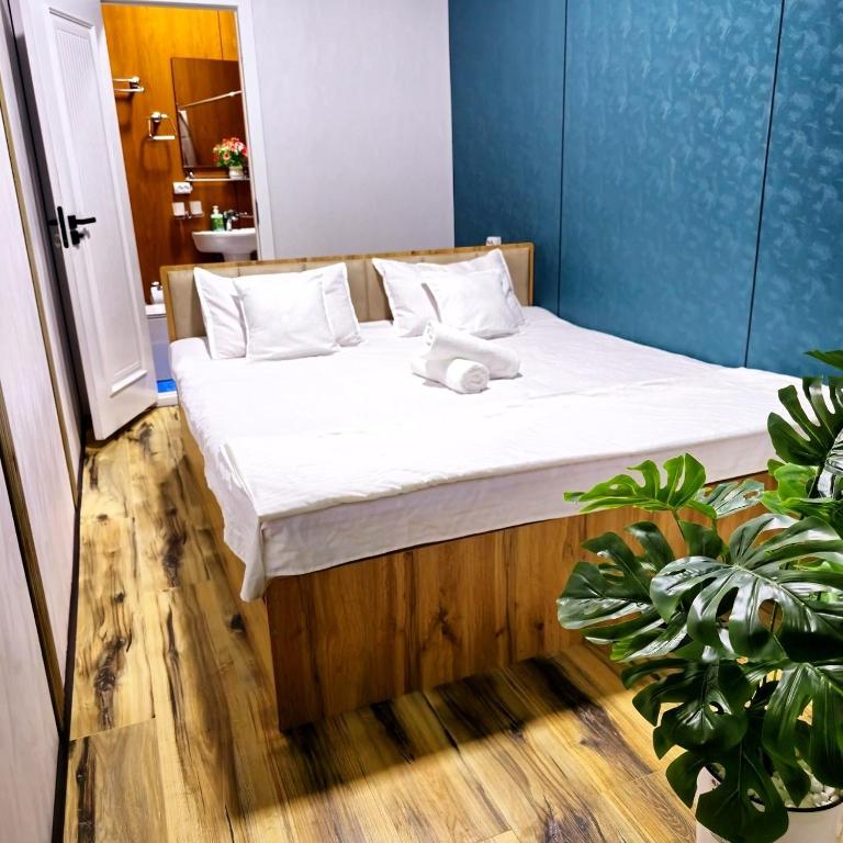 a bedroom with a bed with a teddy bear on it at HALAL apartments in Tashkent city, Metro in Aktepa-Chigatay