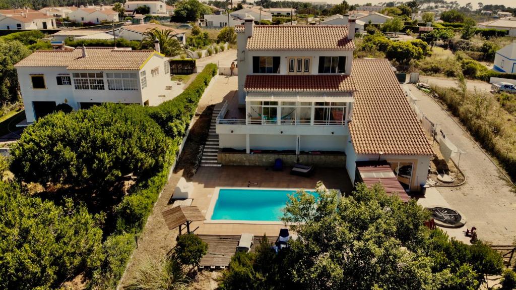 an aerial view of a house with a swimming pool at Mayla Surf House in Aljezur