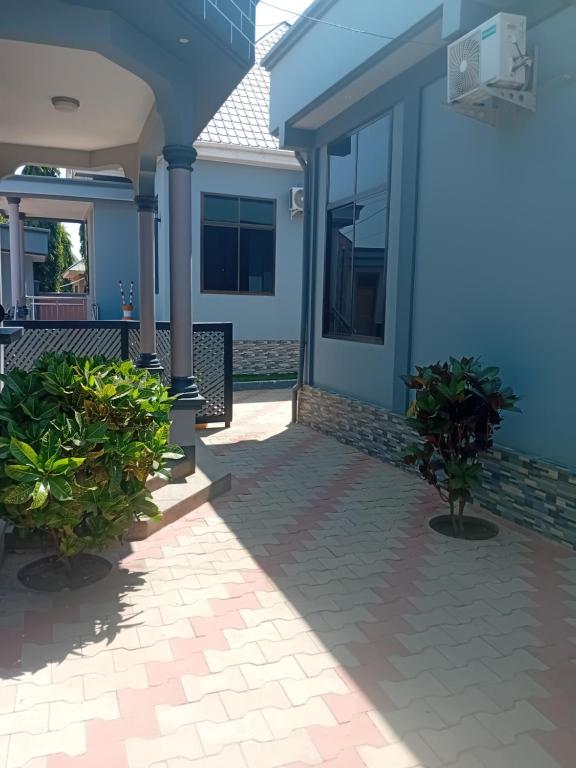 a house with two potted plants in front of it at La Quinta Lodge in Mwanza