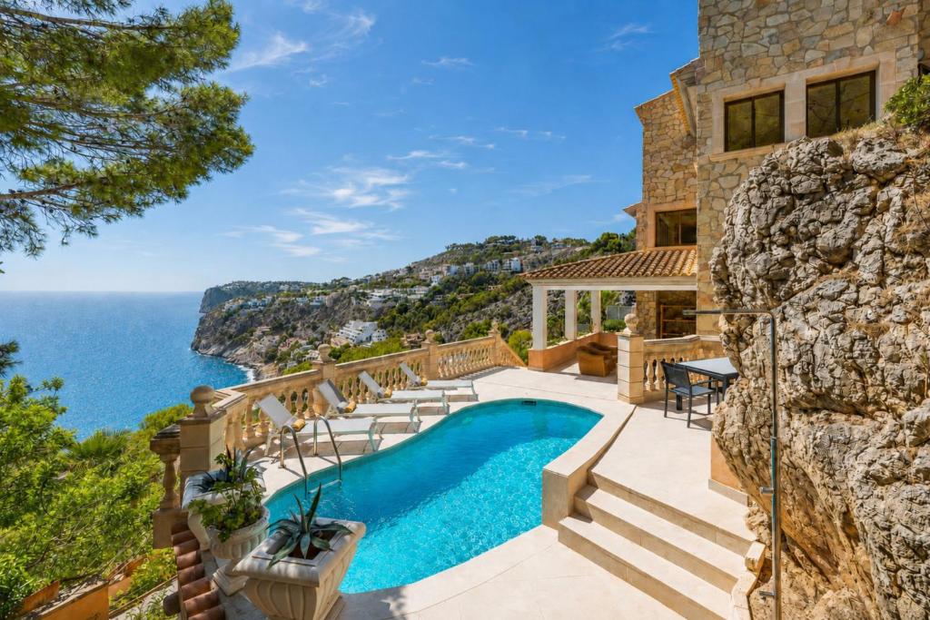 a house on the cliff with a swimming pool and the ocean at Port Andratx - 3444-29 Mallorca in Port d'Andratx