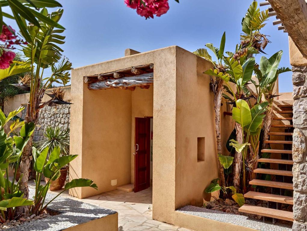 a house with a staircase leading to the entrance at Kasbah 3 in Cala Vadella
