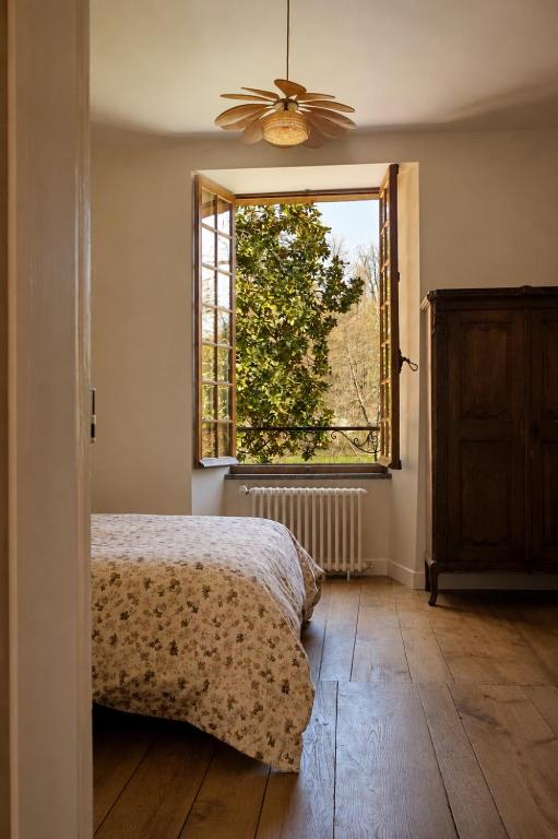 a bedroom with a bed and a window at La Selva in Busserolles