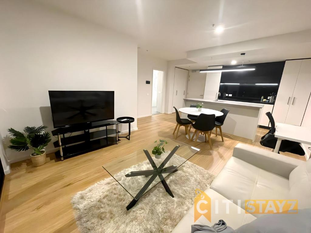 a living room with a couch and a table at Delicious in Dickson - 1bd 1bth in Canberra