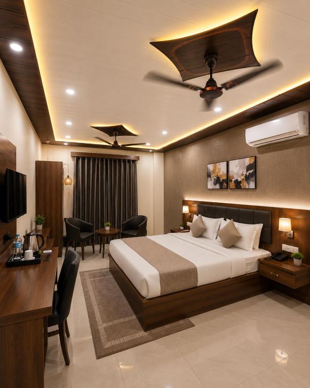 a hotel room with a bed and a desk at Hotel Starlin Near Delhi Airport & Free Airport pickup in New Delhi