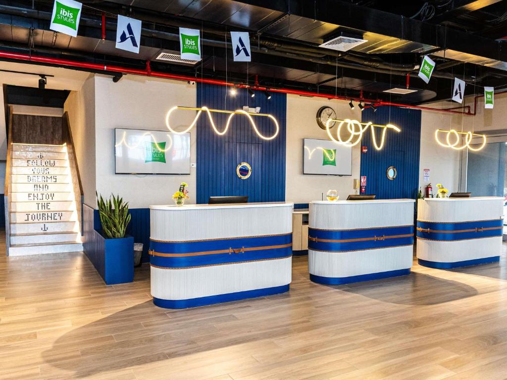 a restaurant with blue and white counters in a room at Ibis Styles El Malecon Guayaquil in Guayaquil