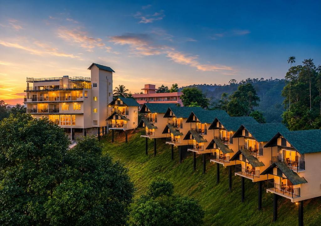 an aerial view of a resort at sunset at Nature Green Pool Resort Munnar by VOYE HOMES in Munnar