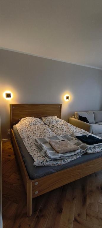 a bedroom with a bed with a wooden frame at Apartament Sobieskiego in Puck