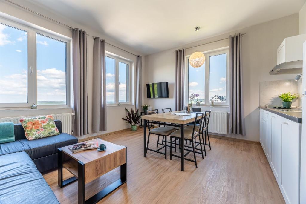 a living room with a couch and a table at Apartamenty Zieleniec in Duszniki Zdrój
