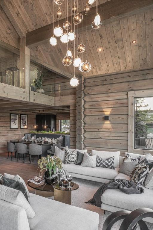 a living room with white couches and a bar at mateja in Mavrovo