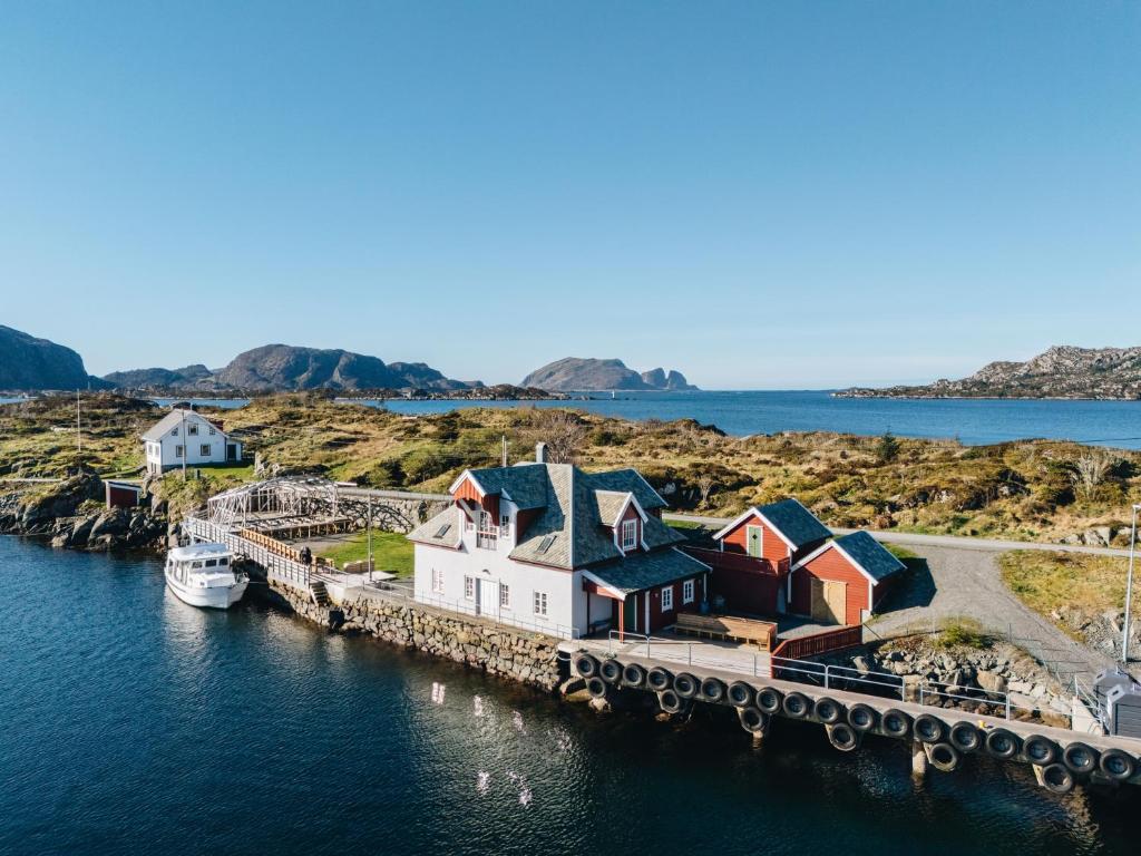 a group of houses on a dock in the water at Batalden Ishus in Kinn