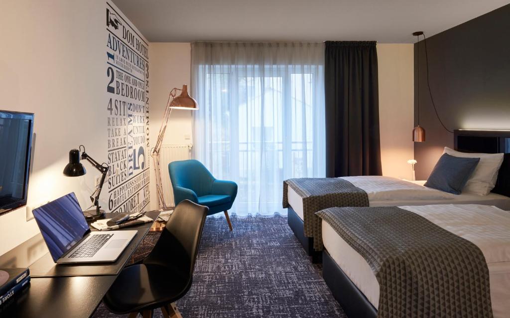 Postel nebo postele na pokoji v ubytování Dom Hotel