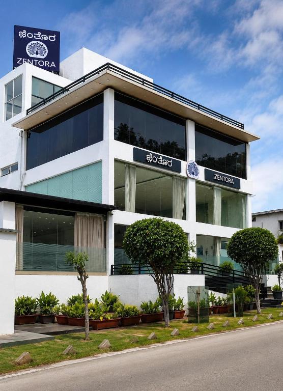 a building with a sign on the side of it at Zentora in Belagula