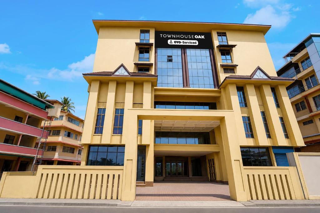 a building with a sign on top of it at Townhouse Oak Kozhikode Bus Stand Formerly Nextel Inn in Kozhikode